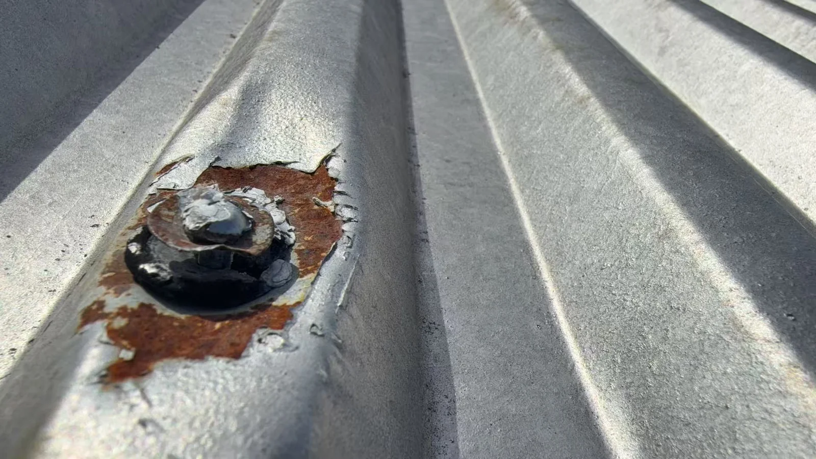 Corrosion around a fastener on a profiled metal roof sheet