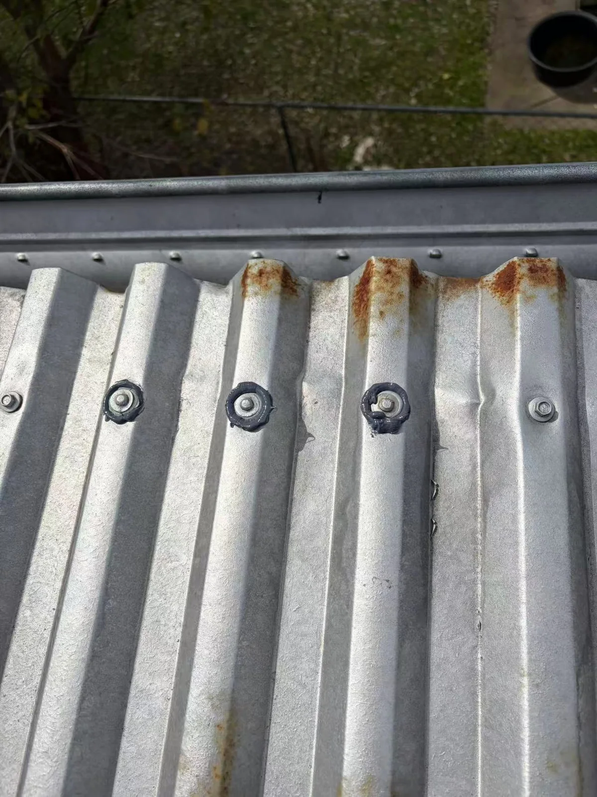 Row of fasteners and surface marks on a metal roof sheet