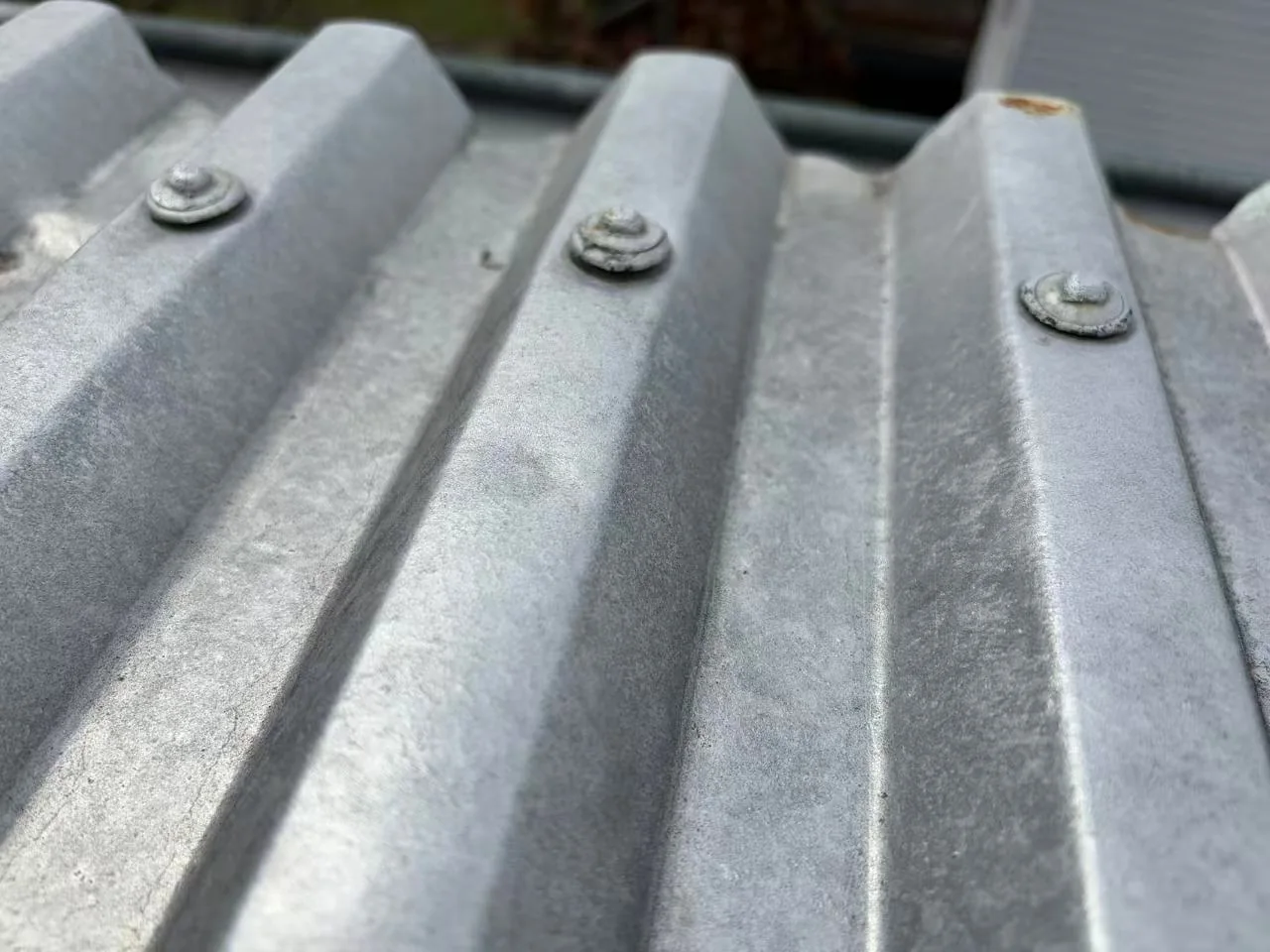 Multiple fasteners across a profiled metal roof sheet