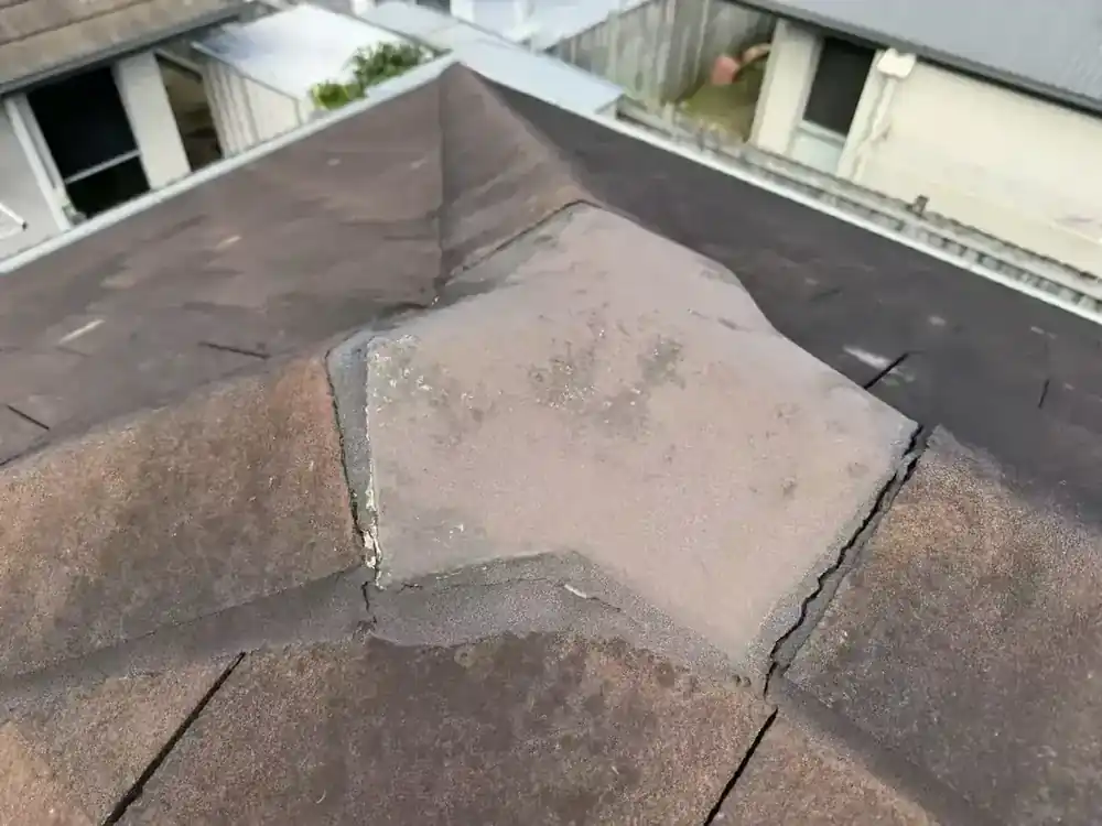 Roof photograph showing cracking around a ridge-capping junction