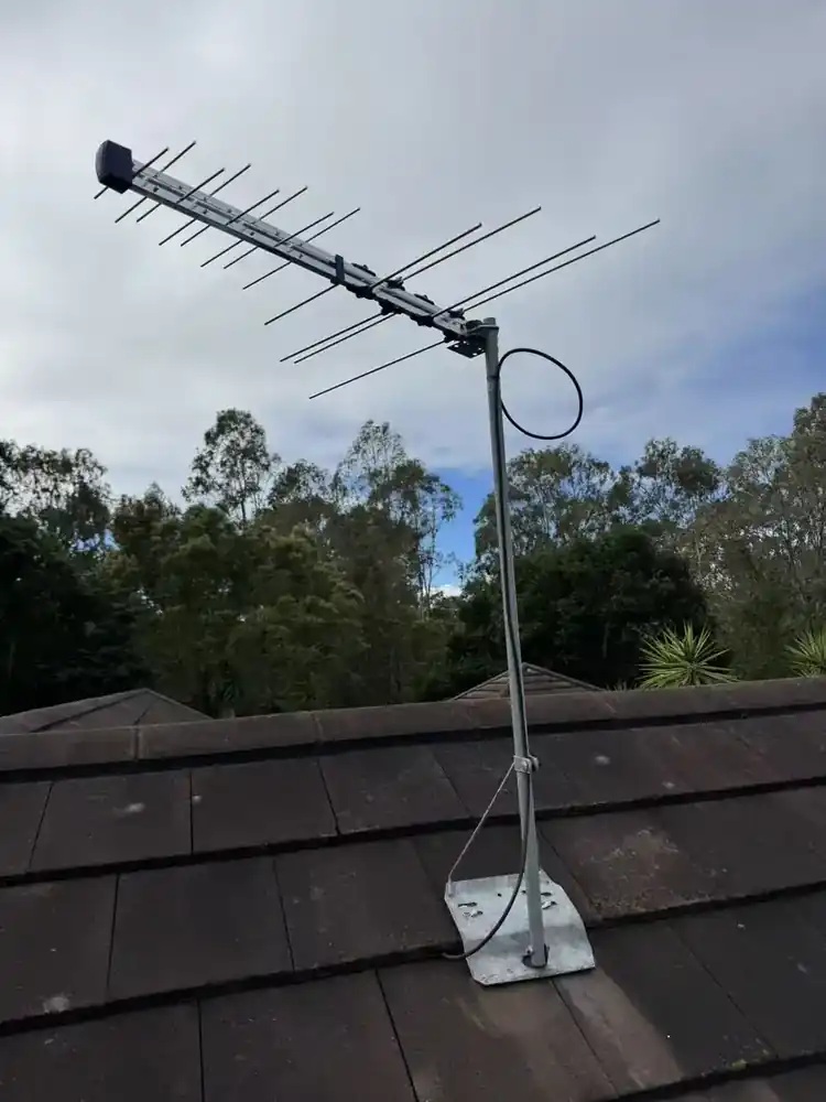 Owner-supplied photograph of a roof antenna penetration and surrounding tiles