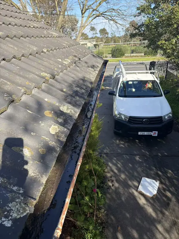 Owner-supplied wide photograph of a tiled roof beside a long roof-drainage channel