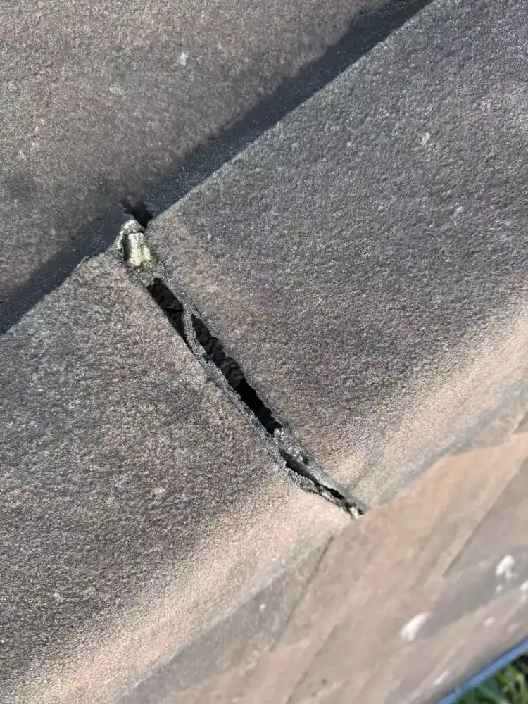 Close owner-supplied photograph of a crack at a tile junction