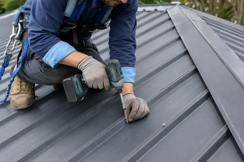 Simulated scene of a harnessed technician checking a metal-roof fastener